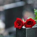 MYSTERY Illness Silences BELOVED Musician Two red roses on a gravestone.