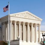 Shocking REVERSAL: Trump Checked — TWICE! United States Supreme Court building with American flag.