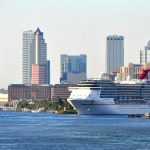 MORAL POLICING Sinks Cruise Ship’s Plans Cruise ship docked near city skyline and water.