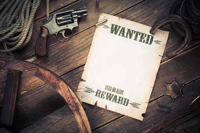 shutterstock_121915636 A vintage wanted poster alongside a revolver and rope on a wooden table