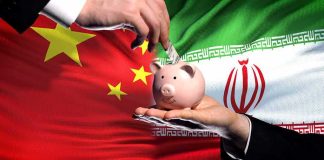 Piggy bank with money against China and Iran flags