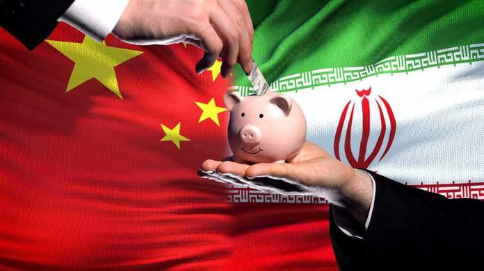 shutterstock_1232742295 Piggy bank with money against China and Iran flags