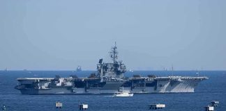 SURPRISE Drone Swarms TARGET U.S. Carriers Aerial view of multiple naval ships operating in the ocean