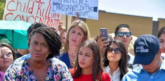 Socialist SURGE — LOOK WHO’S Coming BACK! Speaker at outdoor press conference with crowd and protest signs