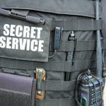 Tactical vest with Secret Service patch and gear