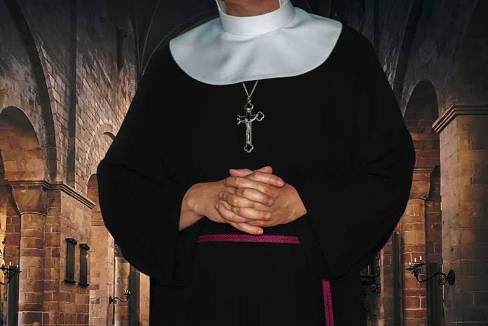 shutterstock_1553012951 Nun in black habit with folded hands