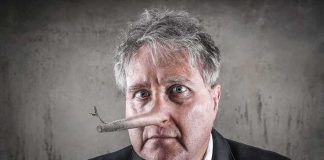 man with a long wooden nose in a suit