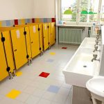RADICAL Obama Judge’s TWISTED Title IX RULING Children's restroom with yellow stalls and white sinks