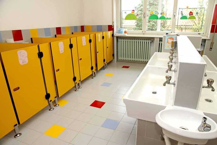 shutterstock_161767796 Children's restroom with yellow stalls and white sinks