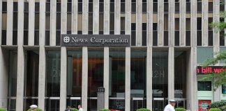 News Corporation building entrance with NYPD car and cyclists