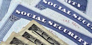Social Security cards with U.S. dollar bills