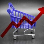 A miniature shopping cart with a rising arrow in the background