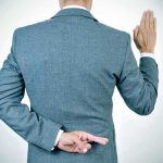 Fauci Stonewalls Senate — WHAT HE’S HIDING Man in suit taking an oath with fingers crossed behind back