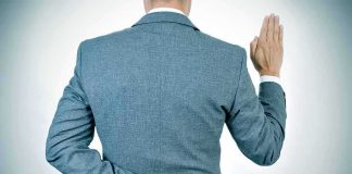 Fauci Stonewalls Senate — WHAT HE’S HIDING Man in suit taking an oath with fingers crossed behind back
