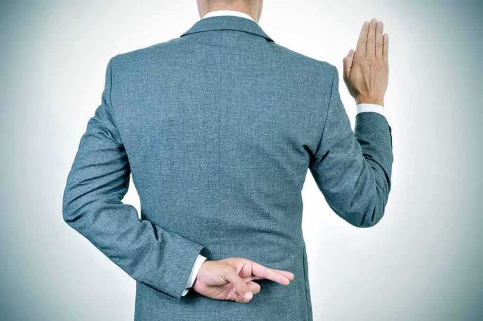 Man in suit taking an oath with fingers crossed behind back