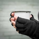 Hunger Strike Hero EXPOSED — What REALLY HAPPENED Hands in fingerless gloves holding a white metal mug