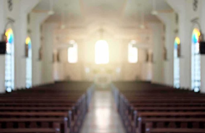 Empty church interior with sunlight at the altar