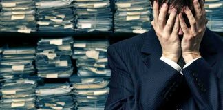 Biden SECRET Tapes EXPOSED — What’s HE Trying To HIDE? Man in suit covering face beside stacks of paperwork