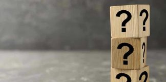 THESE BLURRY Answers Shadows New Spy Boss Three wooden blocks with question marks stacked.