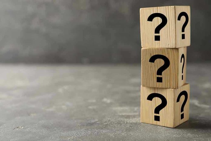 169224694-1 Three wooden blocks with question marks stacked.