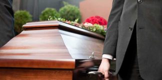 GOP Power Broker DEAD — DC OLD GUARD Scrambles Pallbearer holding a wooden casket handle