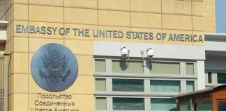 Embassy Alerts — GET OUT NOW! United States Embassy exterior with signage and seal