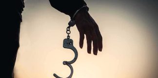 Child Killer WALKS — Totally FREE, No WATCHER! Hand with open handcuff in silhouette at sunset