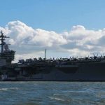 Overboard ALARMS Rock Carrier Aircraft carrier at sea with fighter jets on deck