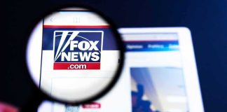 Magnifying glass over Fox News website logo on a tablet