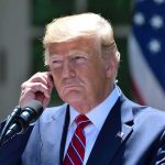 Trump Yanks MODERNIZATION — Steam Is Back! man in suit at podium adjusting earpiece