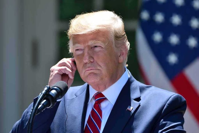 man in suit at podium adjusting earpiece