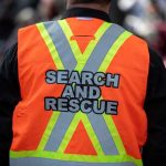 Search and rescue worker in orange reflective vest