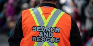 Search and rescue worker in orange reflective vest