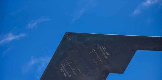Stealth Beats Tehran — AGAIN Stealth aircraft wing seen from below against blue sky