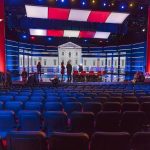 HIJACKED! — Election Night Narrative Spins Out Debate stage with red and blue lighting and empty audience seats
