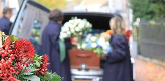 Fans Flood STREETS For Beloved Singer’s FINAL Farewell Funeral flowers with hearse and people in background