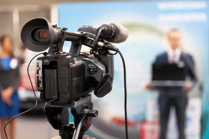 video camera filming a speaker at a podium