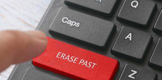 Finger pressing a red keyboard key labeled erase past