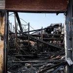 burned warehouse interior seen through open doorway