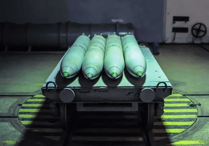 shutterstock_1787893295 Green missiles on a wheeled cart in an industrial bay