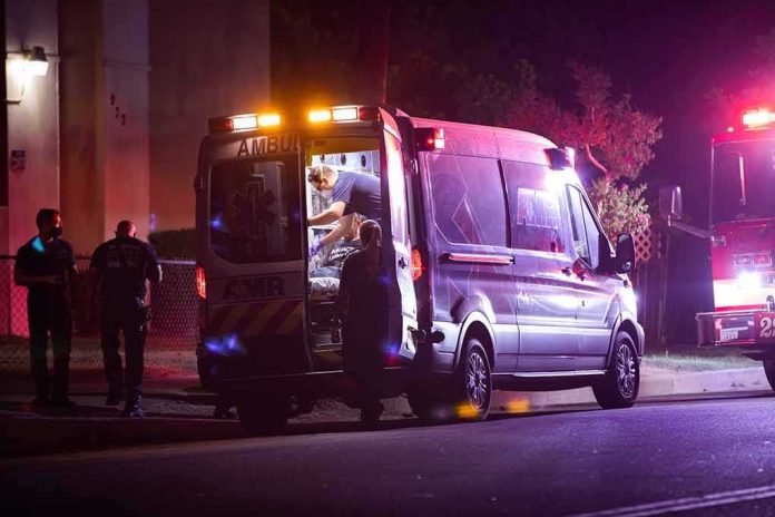 Ambulance at night with paramedics attending a patient