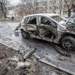 burned-out car with severe damage on a city street