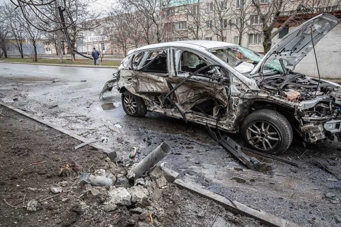 shutterstock_2137424657 burned-out car with severe damage on a city street
