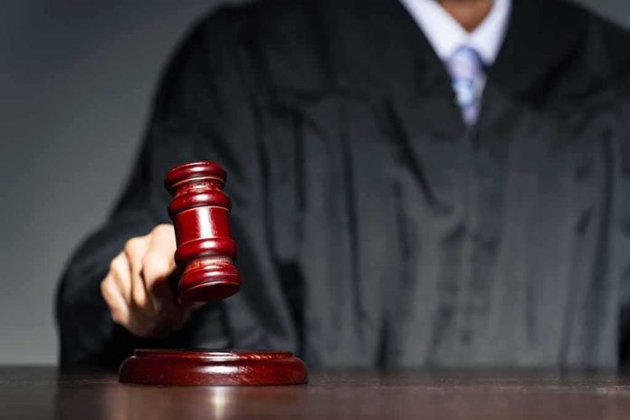 Judge with gavel striking sound block