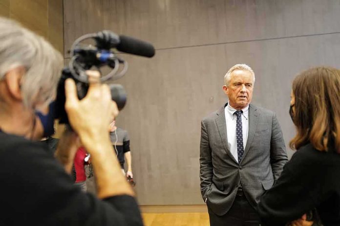 Man in a gray suit speaks to a reporter during an interview