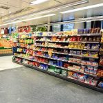 Supermarket aisle with shelves of snacks and candy