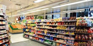 Supermarket aisle with shelves of snacks and candy