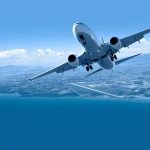 Commercial airplane banking over coastline