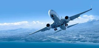 Commercial airplane banking over coastline