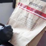 The LEFT is MELTING Over ICE’S Latest Purchase Gloved hands labeling a sealed evidence bag